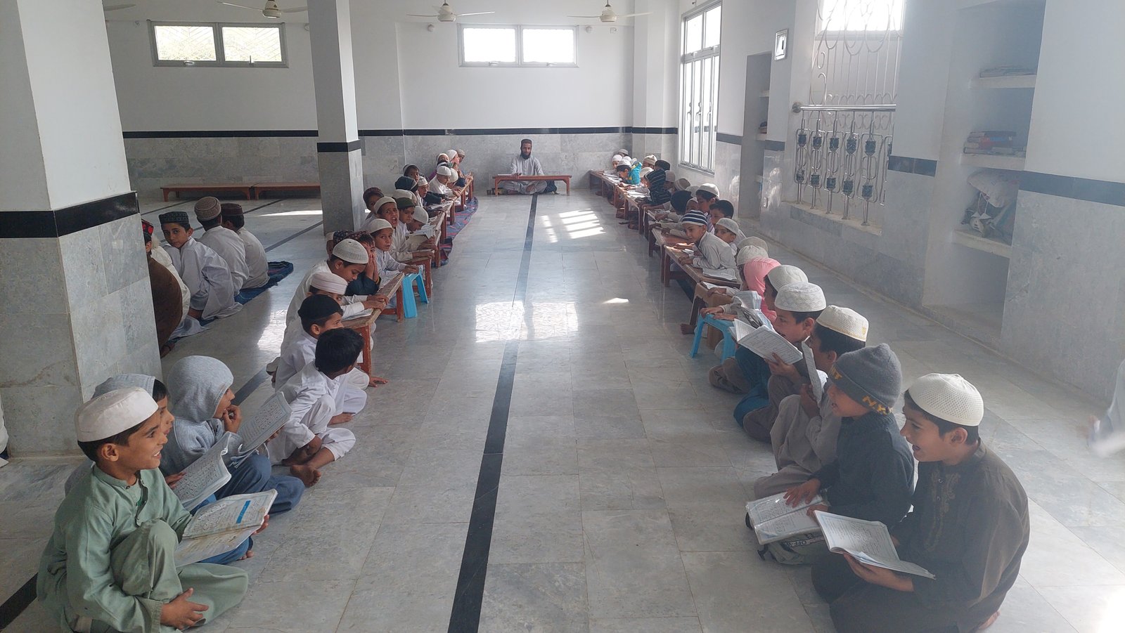 Students seated in a Madrassa classroom for a guided study session